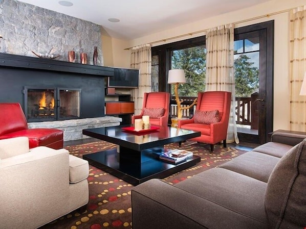 Relax and unwind with a movie or in front of the fireplace in the spacious living area.