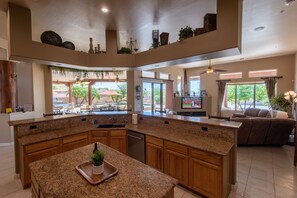 Kitchen looking towards family room and view of outside pool & patio area