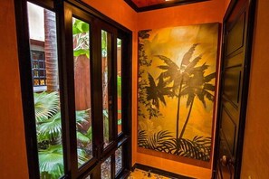  Artwork at entrance opens to tropical garden area