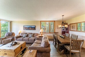 Living area offering cozy furnishings, mountain views, and a wood-burning fireplace.