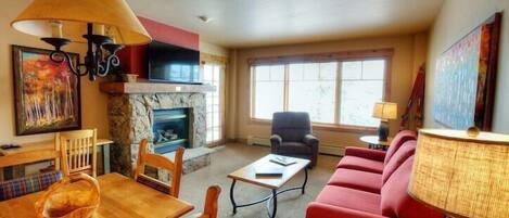 The living area is spacious and the large windows let in lots of natural light