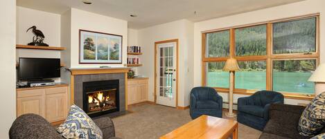 Relax in the cozy living area, complete with fireplace and TV