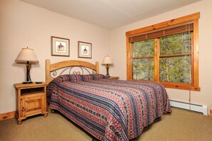 The bedroom features 1 queen bed and a large window