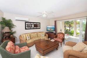 Living area with comfortable sofa and chairs, TV.
