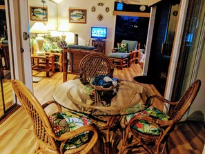 Dining area looking into living room with ocean & mountain views. 