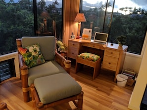 Desk area with large window facing ocean view. 