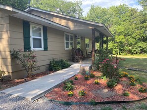 porch leading to front door.  Lockbox is on first pillar.