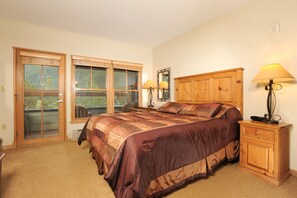 The master bedroom features a comfortable queen bed and access to the private balcony
