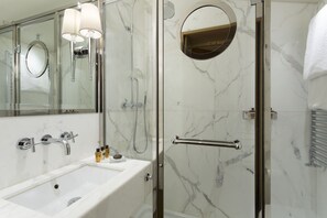 Two Carrara marble bathrooms with luxurious showers, plus a guest bathroom. 