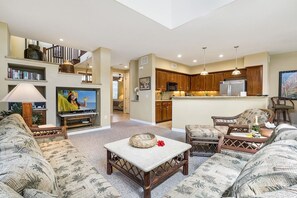 Living Area with Views of the Kitchen and Stairs Leading to the Loft