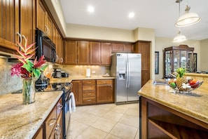 Fully Equipped Kitchen with Granite Counter Tops and Wooden Cabinets