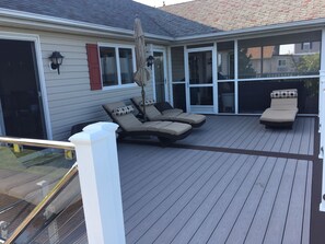 Main deck seating area showing the screened porch entrance