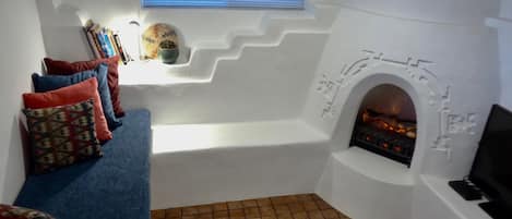 Sunken living room fireplace electric insert providing illumination and heat