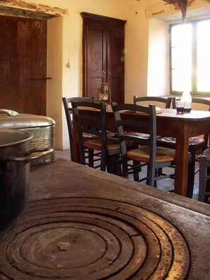 Dinning Room - Original wood table, classic Italian wood stove