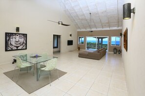 Stylish minimal living/dining room looking out to the sea 