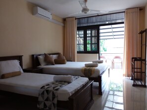 Bedroom 1 with Queen and single size beds. It is opened to a large open-area.