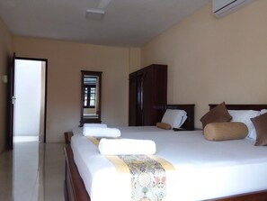 Bedroom 1 has bed-side cupboards, a dressing table, a towel rack & a cupboard.