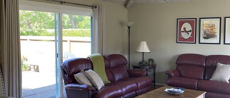 Large Great Room with cathedral ceiling opening to private patio