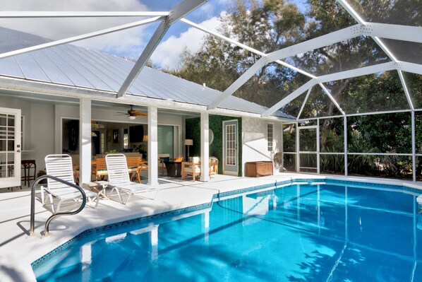 Heated and cooled pool with outdoor living/dining area open to house