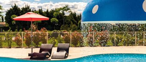 Enjoy relaxing by the outdoor swimming pool.