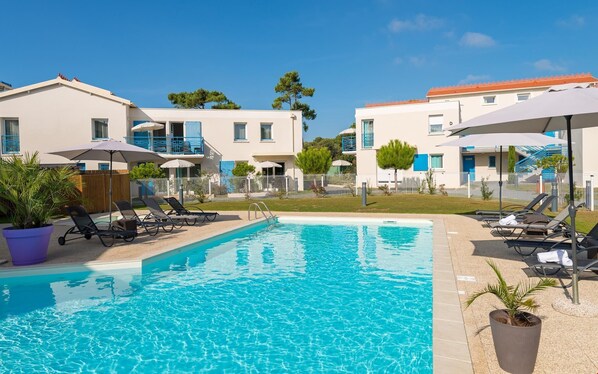 Enjoy the French summer and lounge poolside.