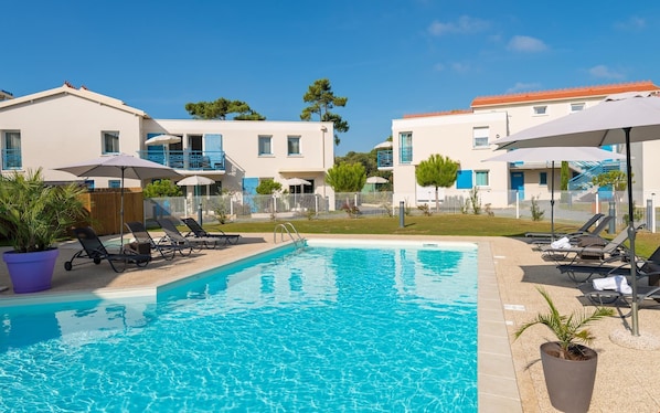 Enjoy the French summer and lounge poolside.