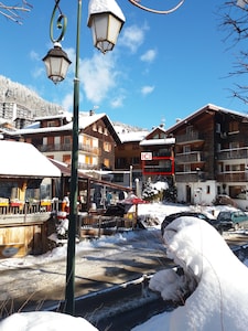 350m from the ski lifts, parking, in the village of La Clusaz