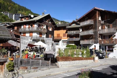 350m from the ski lifts, parking, in the village of La Clusaz