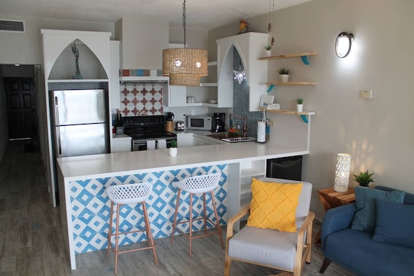 Kitchen with a Mexican-Surfy Vibe. Fully equipped with most things you should need including a bonus beverage refrigerator!