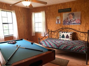 Pool table and day bed in open loft.