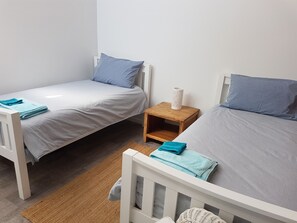 Good size twin room with split system cooling & heating.  ( angle 1)