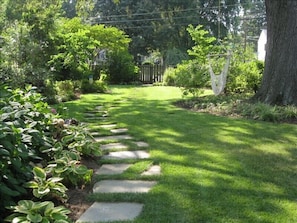 fenced back yard with tree swing