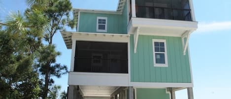 View of the home from the road. Plenty of parking underneath the home