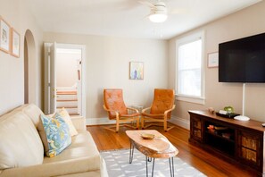 Open living room with seating, two ground floor bedrooms, dining and kitchen!