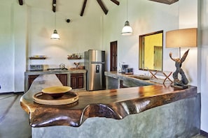 Fully equipped kitchen to the right of the front door