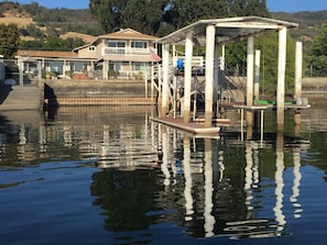 View of the house and boat lift from the lake.