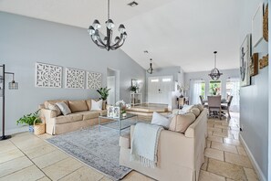 Walk in and be greeted by the spacious great room with views of the pool.