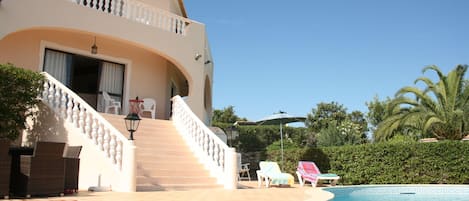The majestic staircase and poolside from which to relax and admire the views