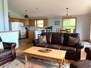 Main floor great room with TV and plenty of seating.
