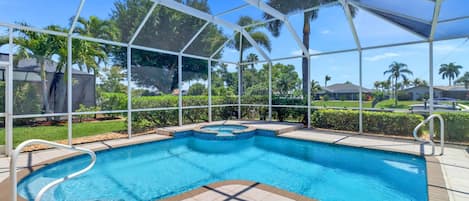 Your own tropical oasis includes a private heated pool and spa in a fully enclosed screened lanai, located on a Gulf access canal.