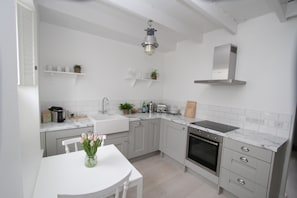 Fully equipped contemporary kitchen with butler sink & vintage lighting