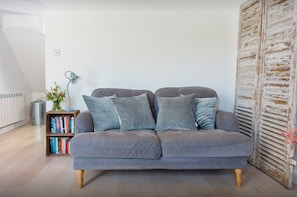 The comfy sofa and plump cushions are perfect for curling up and relaxing