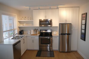 Bright, fully stocked kitchen with all that you need.