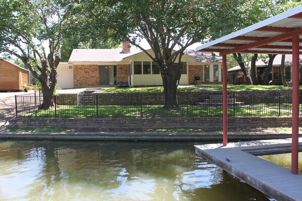 Photo from the dock swim platform looking at back yard.