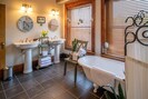 The bathroom is spacious with two sinks, a shower and a bathtub. 