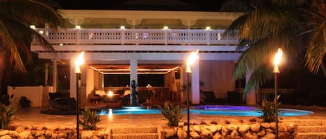 View of house from water at evening
