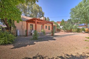 backyard with pergola, outdoor dining, and grill