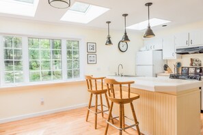 Breakfast bar in fully stocked kitchen