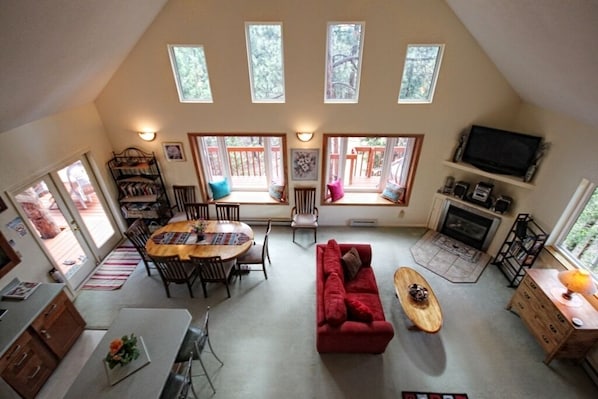 The Great Room with large bay windows and views to woodland and mountains