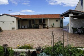 View of rear of the Beach House from the veggie patch with the ocean view.